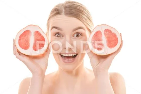 The attractive woman holding a grapefruit on the white background Stock Photos
