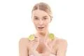 The attractive woman holding a lime on the white background Photo
