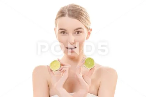 The attractive woman holding a lime on the white background Stock Photos