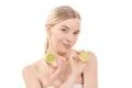 The attractive woman holding a lime on the white background Photo