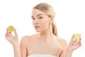 The attractive woman holding a lime on the white background Photo