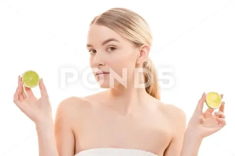 The attractive woman holding a lime on the white background Stock Photos