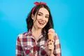 The attractive woman with an ice cream on the blue background Photo