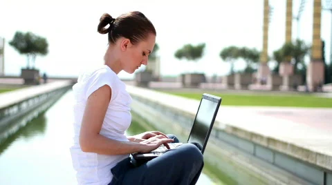 Attractive woman with laptop, outdoors Stock Footage