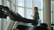 Attractive Woman Of Middle Age Is Running On Tread Mill In Sport Gym Stock Footage