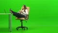 The attractive woman relaxing at the table on the green background 4k or 4k+ Resolution