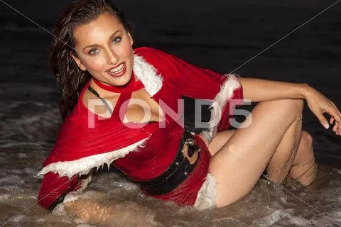 Attractive woman in Santa Claus costume Stock Photos