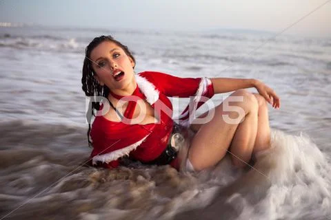 Attractive woman in Santa Claus costume Stock Photos