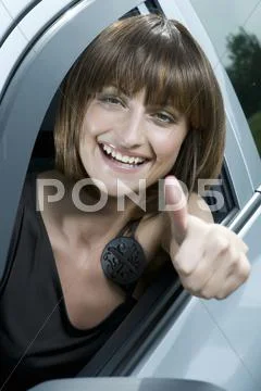 Attractive woman showing a success sign Stock Photos