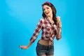 The attractive woman standing with an ice cream on the blue background Photo