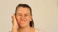 Attractive woman suffering from painful earache HD Footage
