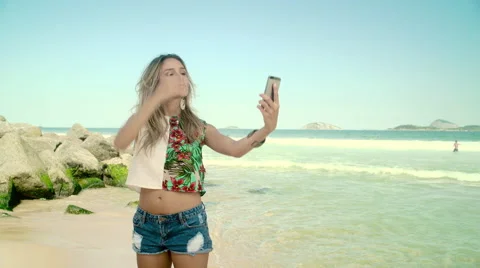 Attractive woman taking a selfie on smartphone at Ipanema beach Stock Footage 59376229