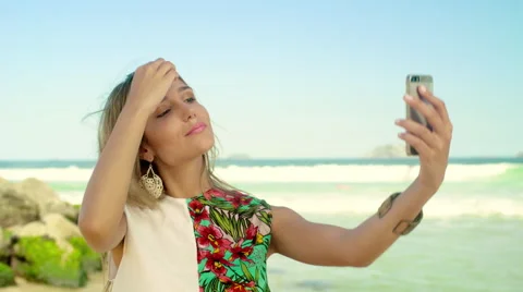 Attractive woman taking a selfie on smartphone at Ipanema beach Stock Footage 59376324