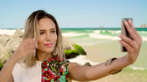 Attractive woman taking a selfie on smartphone at Ipanema beach Stock Footage 59376477