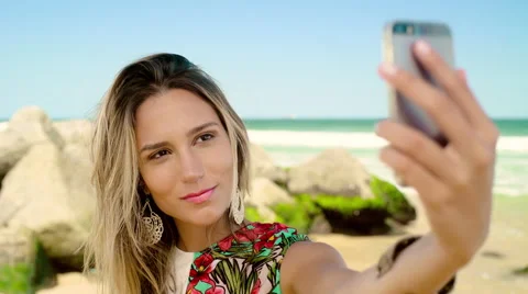 Attractive woman taking a selfie on smartphone at Ipanema beach Stock Footage 59442021
