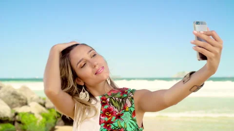 Attractive woman taking a selfie on smartphone at Ipanema beach Stock Footage 59442047