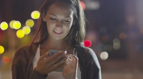 Attractive Woman using Mobile Phone During Walk on Streets of Night Town Stock Footage