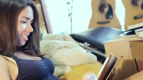 Attractive woman using tablet computer sitting on the couch Stock Footage 54938560