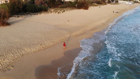Attractive Woman Walking on the Beach at the Sunset, Aerial Stock Footage 119442853