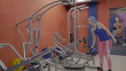 Attractive woman wide grip pulldowns in machine in gym. Stock Footage 83344184