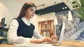 The attractive woman working with a laptop and phones 4k or 4k+ Resolution