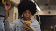 Attractive Young African American Woman Holds The Handrail And Using Smartphone Stock Footage