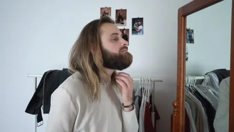 Attractive young bearded man is Combing His Beard Stock Footage 147899533