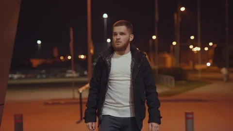 Attractive young bearded man in stylish outfit walking in the street wof Stock Footage 117429795