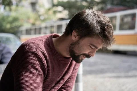 Attractive young bearded man using his smartphone in the cafe Stock Photos