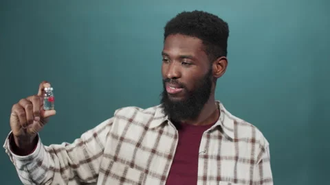 An attractive young black man shows an ampule with vaccine Stock Footage 170801467