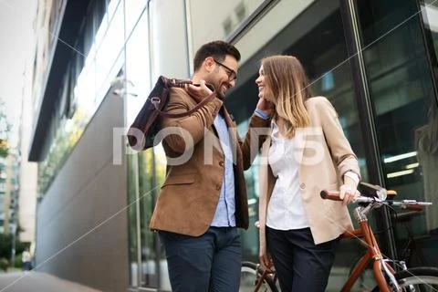 Attractive young business couple embracing at street Stock Photos