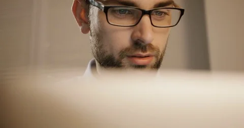 Attractive young business man working at laptop in office. Business man in Stock Footage