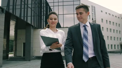 Attractive young business people are doing business outdoors Stock Footage