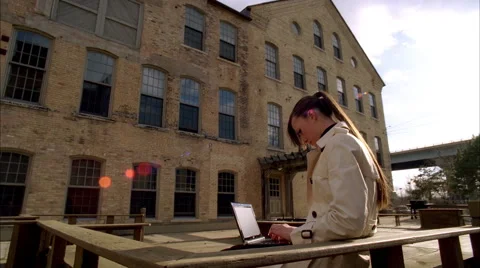 Attractive young business woman on her laptop outdoors Stock Footage