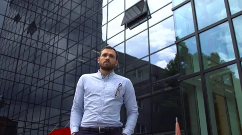 Attractive young businessman checking time on his watch Stock Footage 64120821