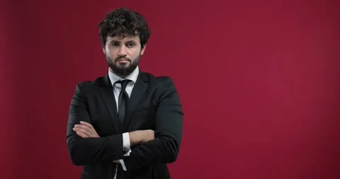 Attractive, young businessman checking the time with his wristwatch, isolated Stock Footage 136885297