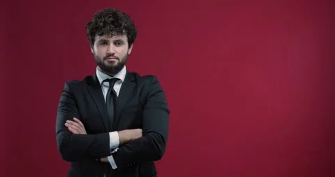 Attractive, young businessman checking the time with his wristwatch, isolated Stock Footage 136885568