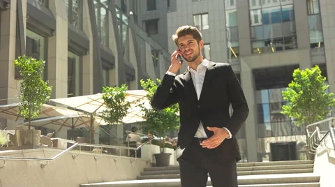 Attractive young businessman using a cell phone, smiling. Stock Footage 66365826