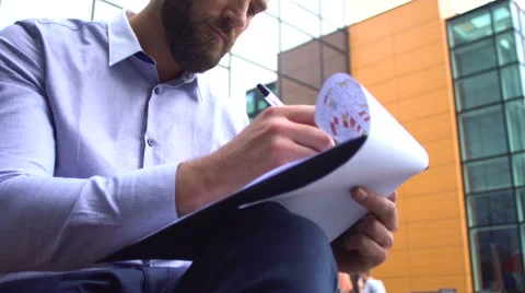 Attractive young businessman working on his project Stock Footage 65965553