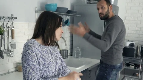 Attractive young couple arguing in the kitchen Stock Footage