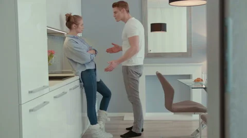 Attractive young couple arguing in the kitchen. Stock Footage 86716137