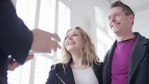 Attractive young couple shake hands on buying a property Stock Footage