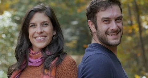 Attractive young couple standing back to back turn and smile at the camera Video stock 101445587