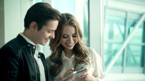 Attractive young couple with technology Stock Footage 69206688