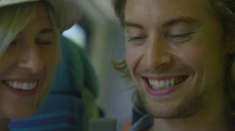 Attractive young couple on a train looking at something on a phone together Video stock 51894175