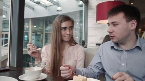 Attractive young couple using smartphone at cafe Look at the display smiling Stock Footage 74811110