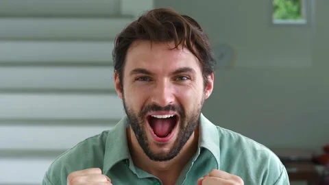 Attractive young dark-haired and bearded European guy looks at the camera Stock Footage 222135896