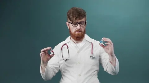 An attractive young doctor compares two ampules with vaccine and shows the Stock Footage 170676988