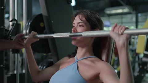 Attractive young female doing exercises fitness training chest muscles on mac Video stock 219259059