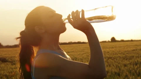 Attractive Young Female Model Drinking Water Bottle Sunset Vídeo Stock 39022172